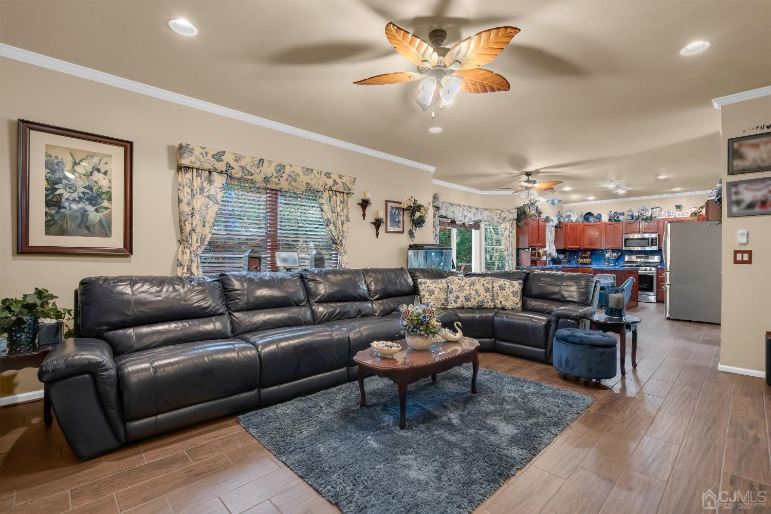 1416 Princess Avenue Brick, NJ 08724 - Photo 13 of 39 a living room with furniture kitchen view and a chandelier