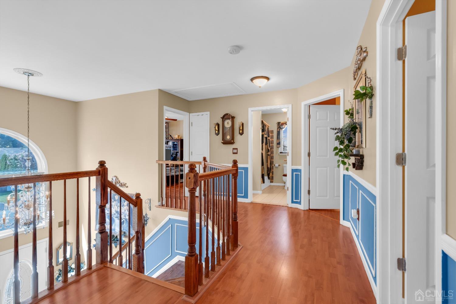 1416 Princess Avenue Brick, NJ 08724 - Photo 23 of 39 a view of a hallway with wooden floor and stairs