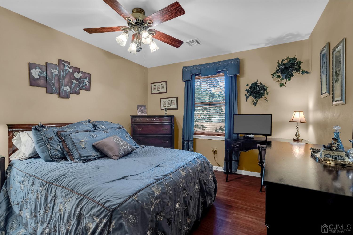 1416 Princess Avenue Brick, NJ 08724 - Photo 30 of 39 a bedroom with a bed and a chandelier