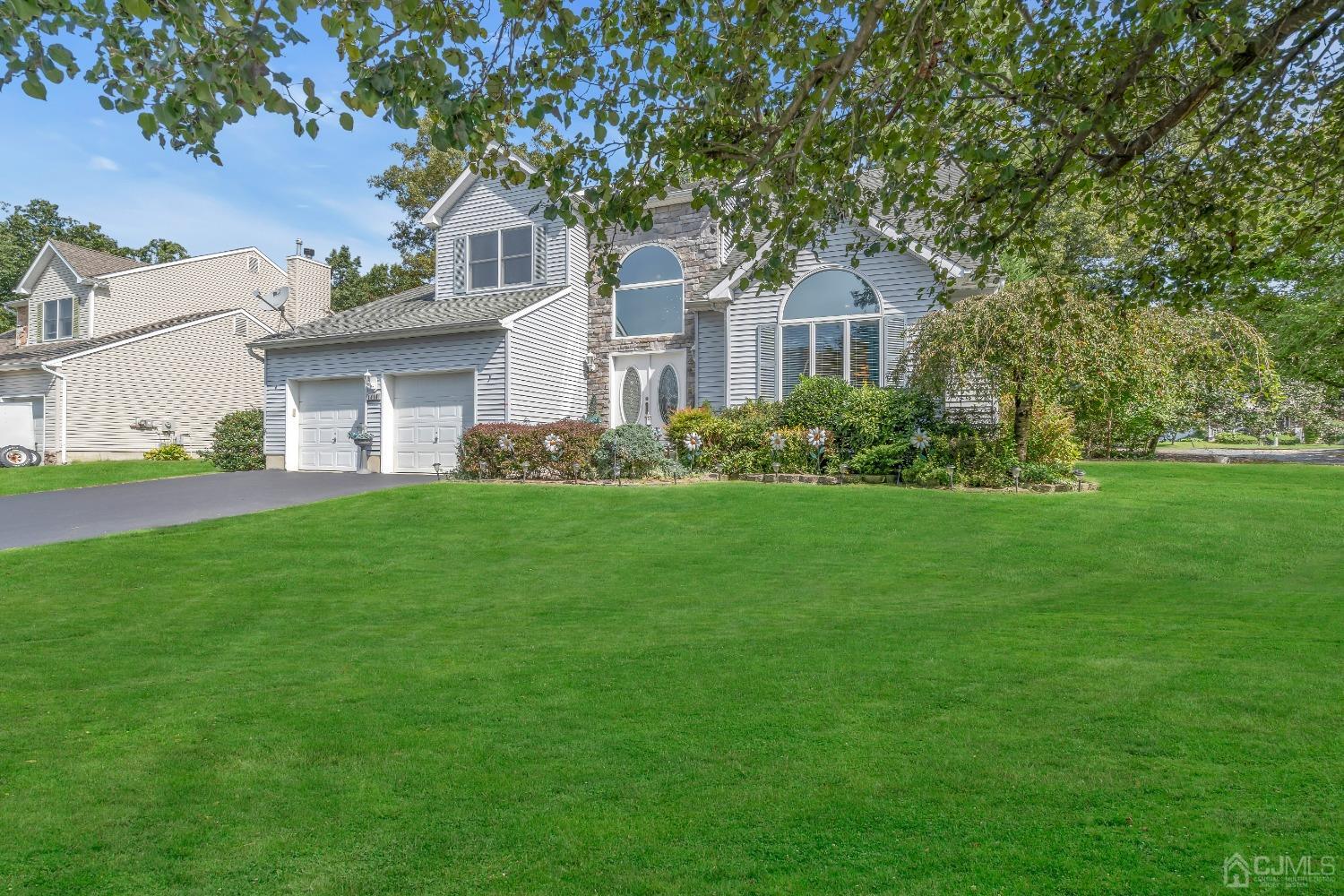 1416 Princess Avenue Brick, NJ 08724 - Photo 3 of 39 a front view of a house with a garden