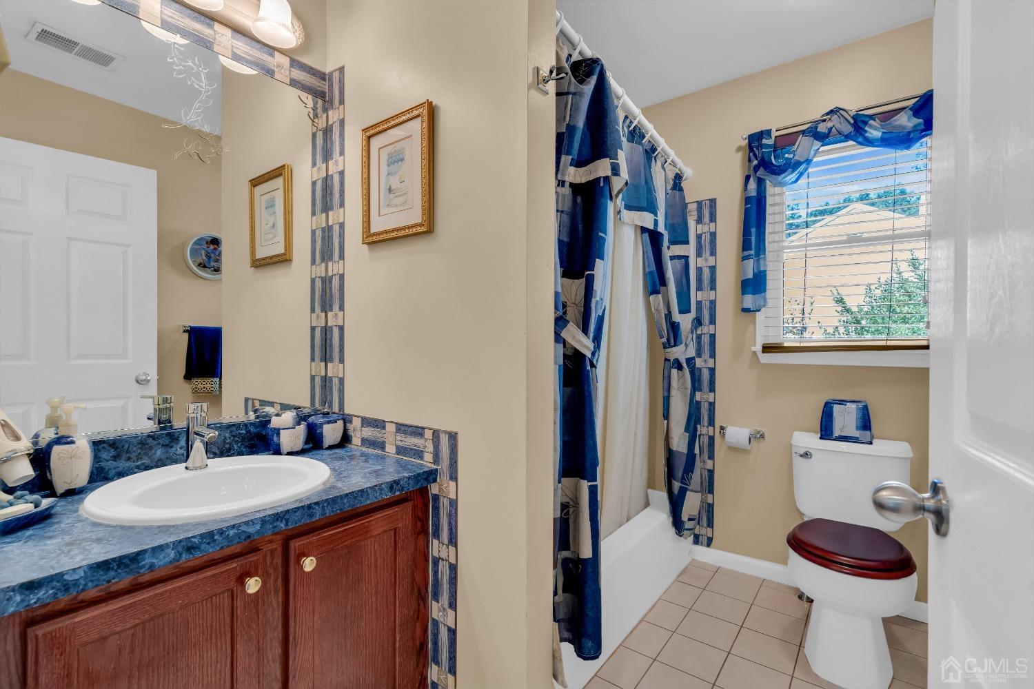 1416 Princess Avenue Brick, NJ 08724 - Photo 31 of 39 a bathroom with a granite countertop sink mirror vanity and toilet