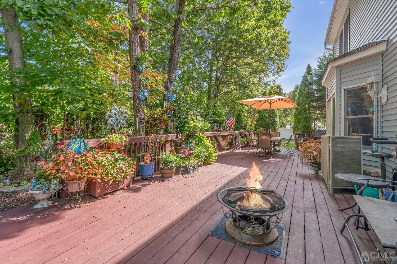 1416 Princess Avenue Brick, NJ 08724 - Photo 35 of 39 a view of a table and chairs under an umbrella on wooden deck