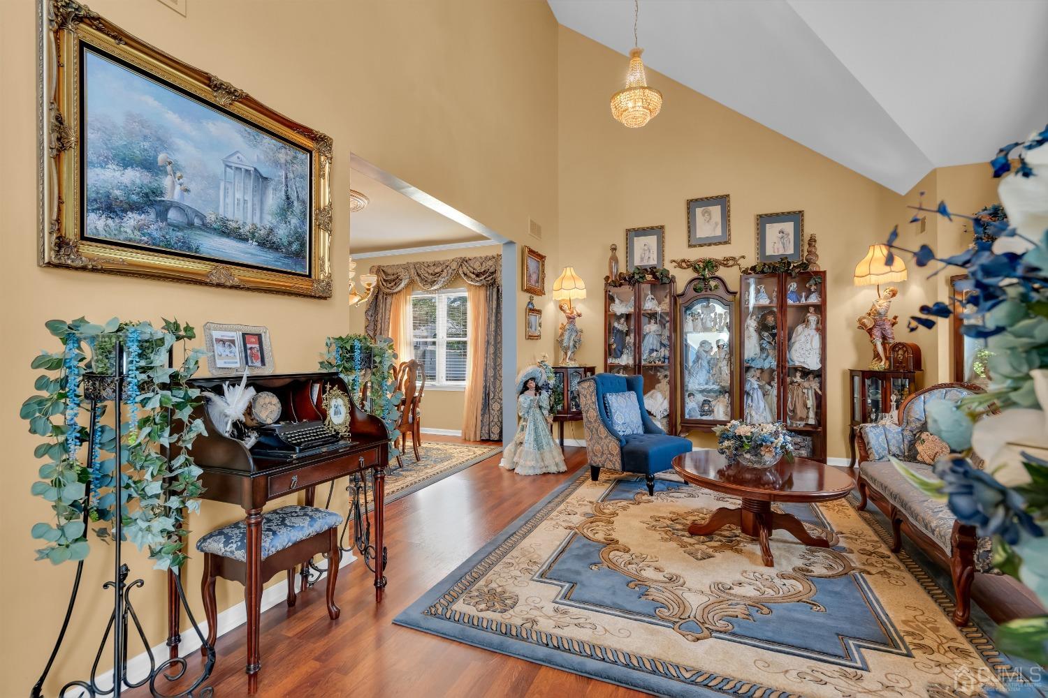 1416 Princess Avenue Brick, NJ 08724 - Photo 8 of 39 a living room with lots of furniture and paintings on the wall