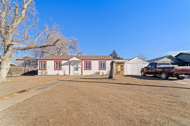 a view of a house with a yard and sitting area