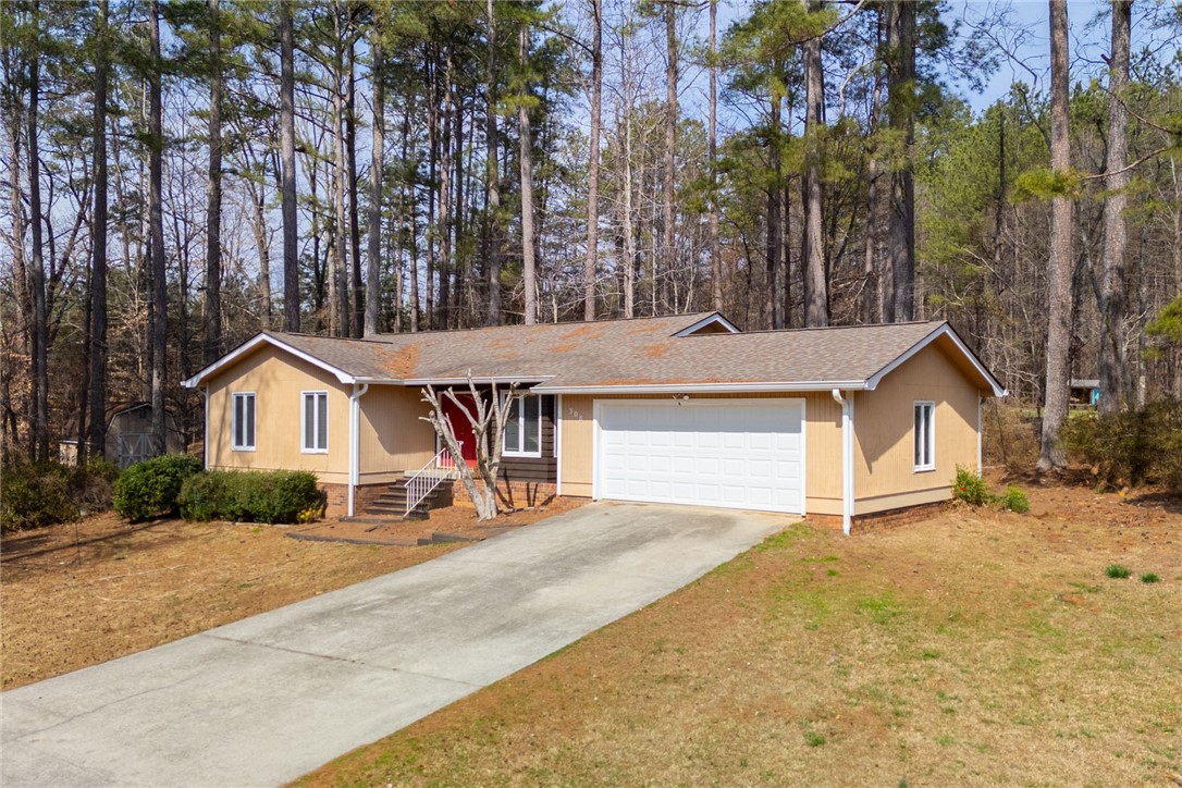 308 Wildwood Road Walhalla, SC 29691 - Photo 23 of 23 A charming single-story residence is nestled amongst tall trees, offering a private retreat.