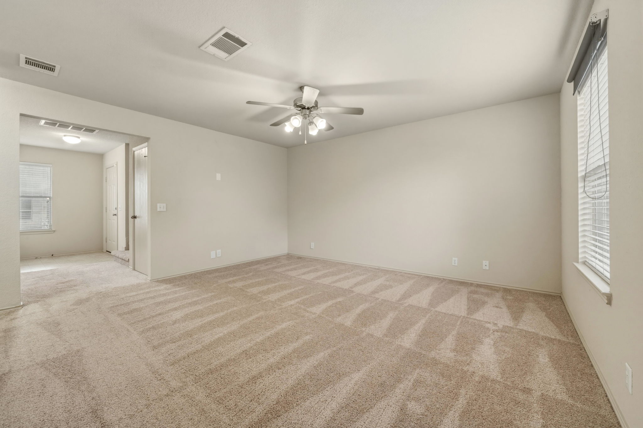 4528 Best Way Austin, TX 78725 - Photo 11 of 40 Unfurnished room with ceiling fan and light carpet