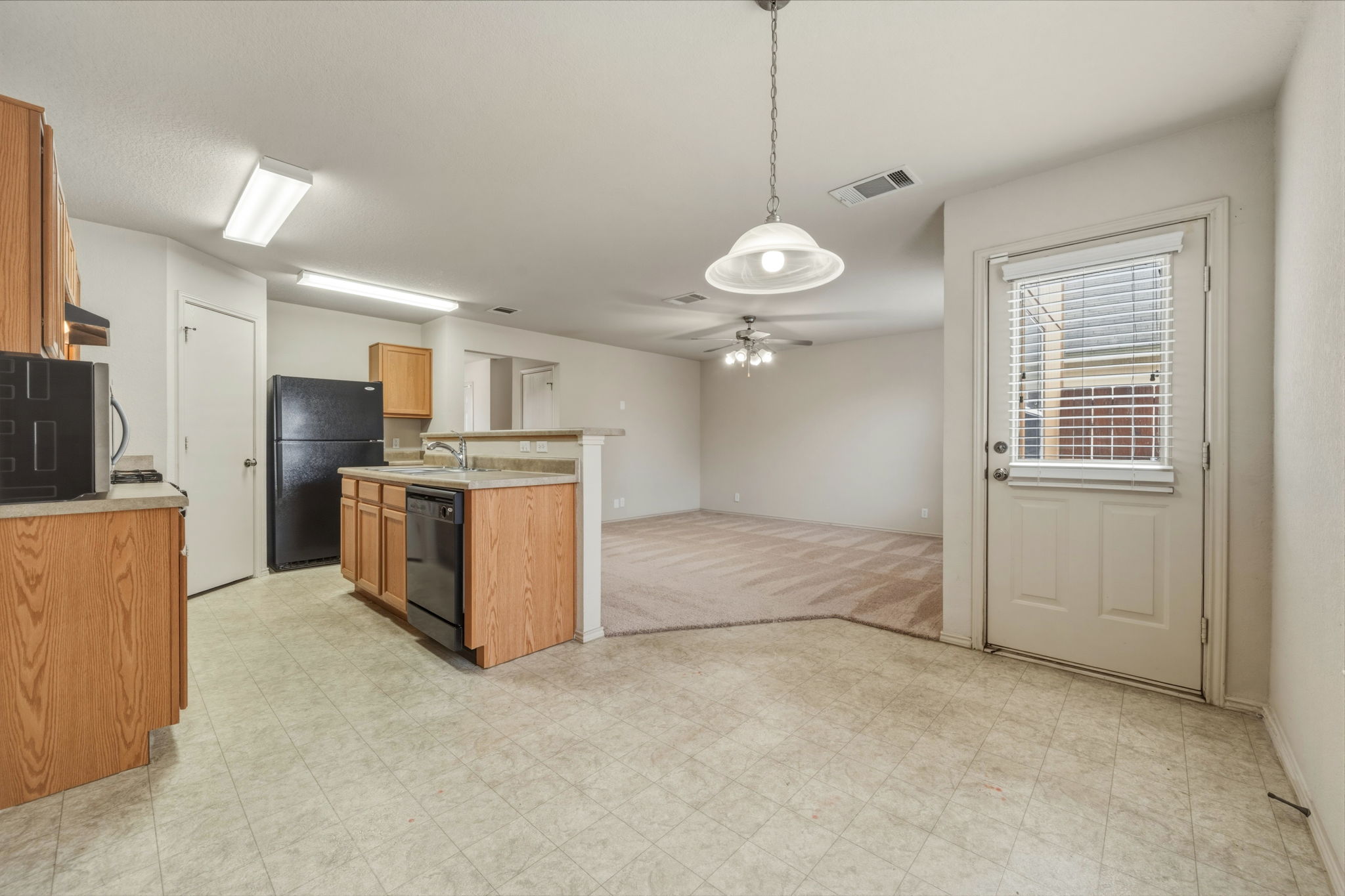 4528 Best Way Austin, TX 78725 - Photo 40 of 40 Kitchen with light countertops, open floor plan, black appliances, and light flooring