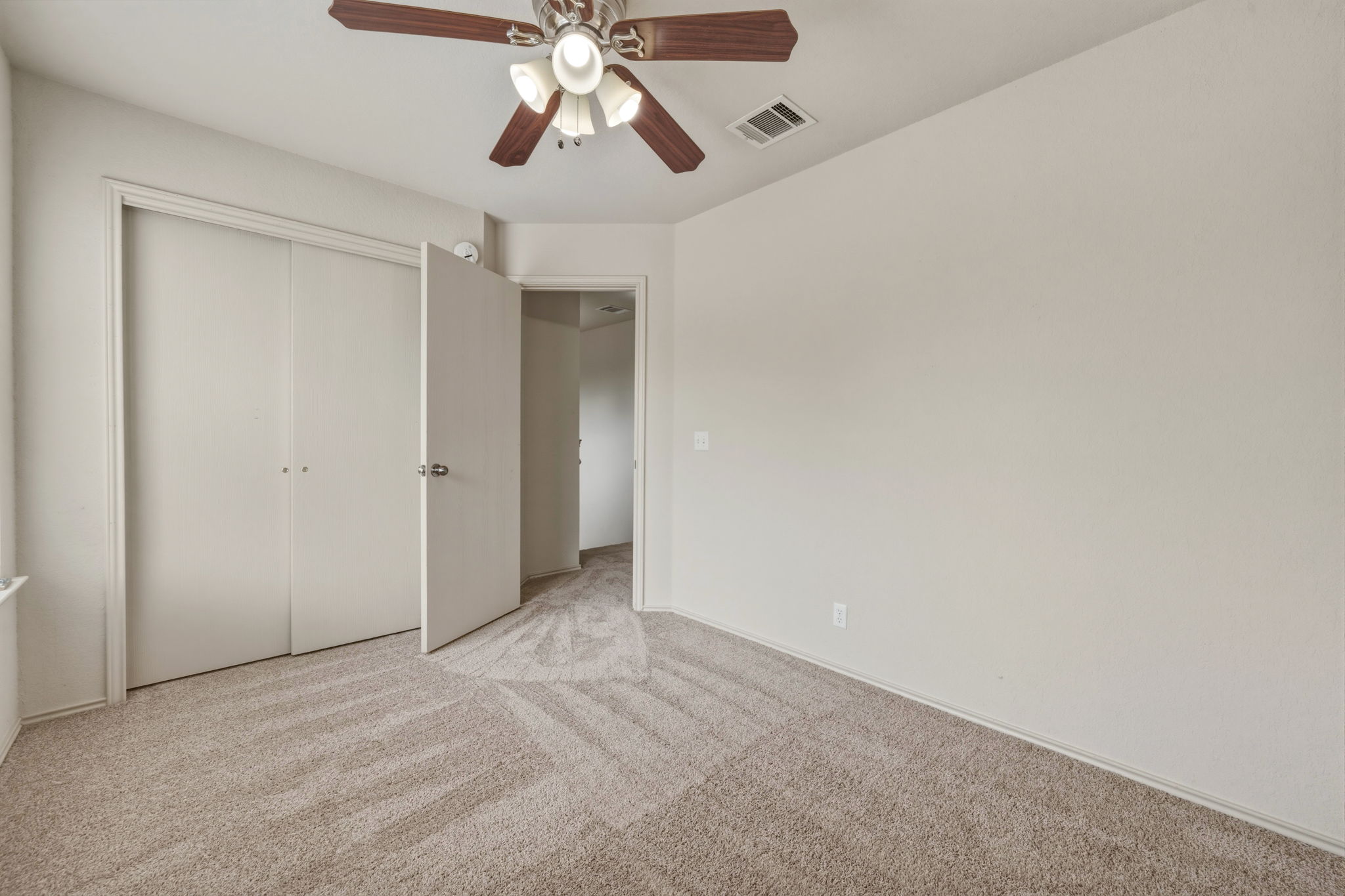 4528 Best Way Austin, TX 78725 - Photo 21 of 40 Unfurnished bedroom featuring light colored carpet, a closet, and ceiling fan