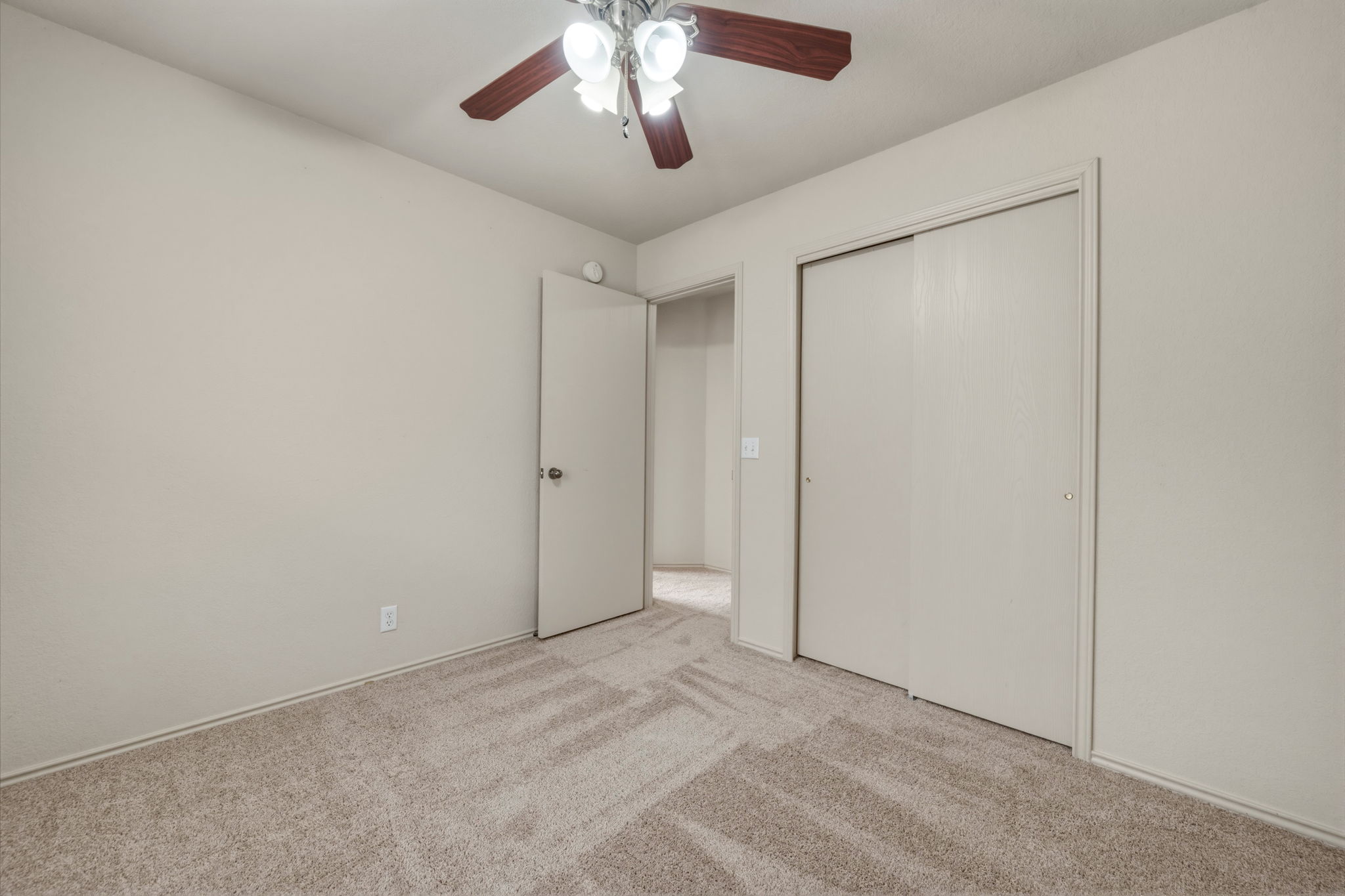 4528 Best Way Austin, TX 78725 - Photo 25 of 40 Unfurnished bedroom with light carpet, ceiling fan, and a closet