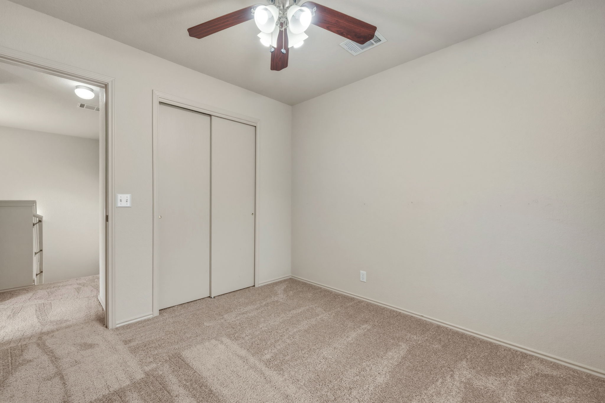4528 Best Way Austin, TX 78725 - Photo 26 of 40 Unfurnished bedroom with light carpet, a closet, and ceiling fan
