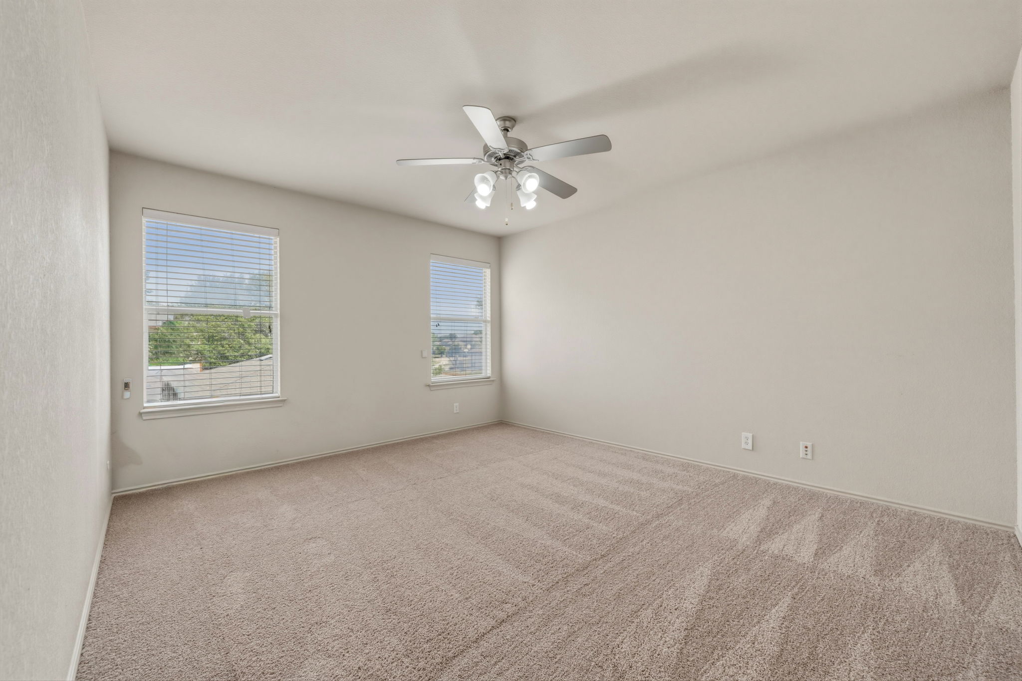 4528 Best Way Austin, TX 78725 - Photo 28 of 40 Unfurnished room featuring light carpet and ceiling fan