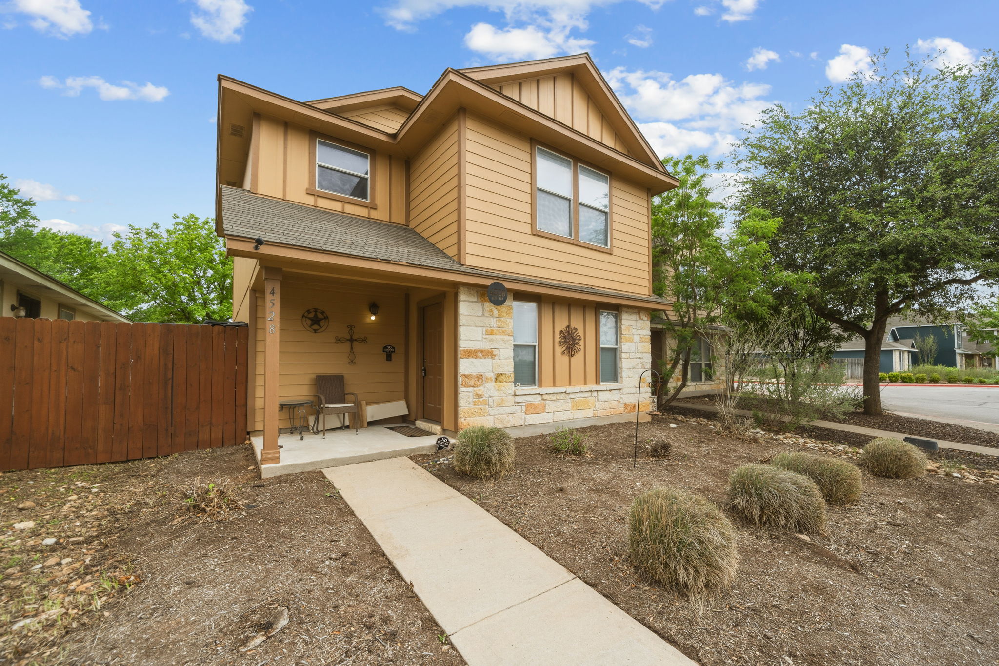 4528 Best Way Austin, TX 78725 - Photo 3 of 40 View of front facade with board and batten siding and stone siding