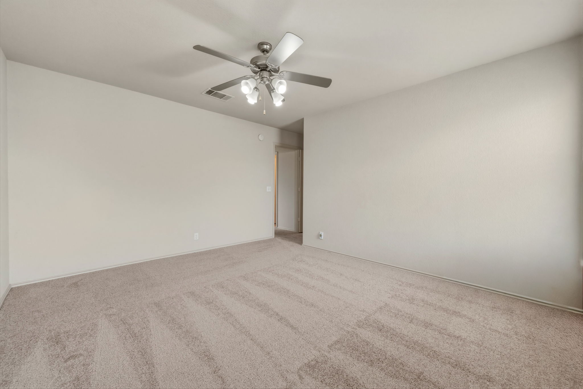 4528 Best Way Austin, TX 78725 - Photo 30 of 40 Unfurnished room with light colored carpet and ceiling fan
