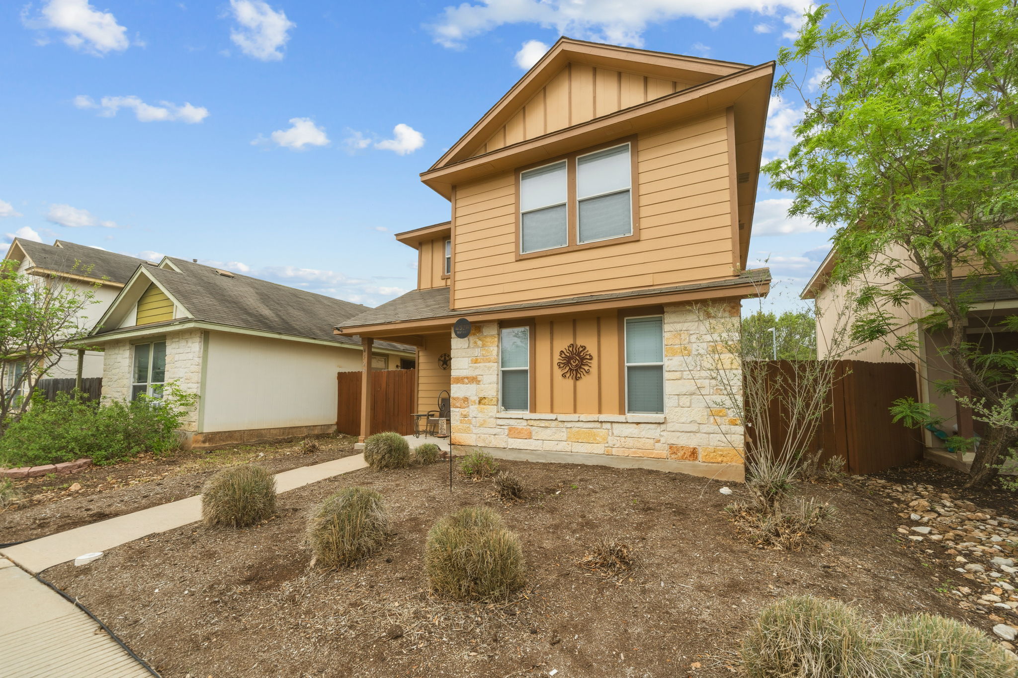 4528 Best Way Austin, TX 78725 - Photo 4 of 40 View of front of house with board and batten siding and stone siding