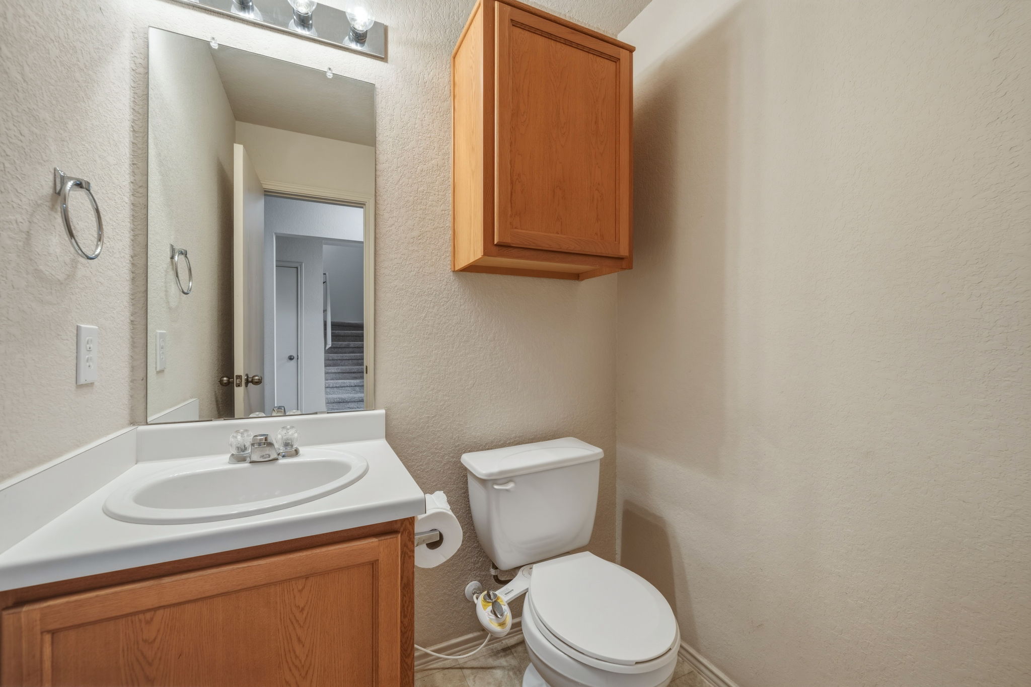 4528 Best Way Austin, TX 78725 - Photo 7 of 40 Half bathroom with a textured wall and vanity