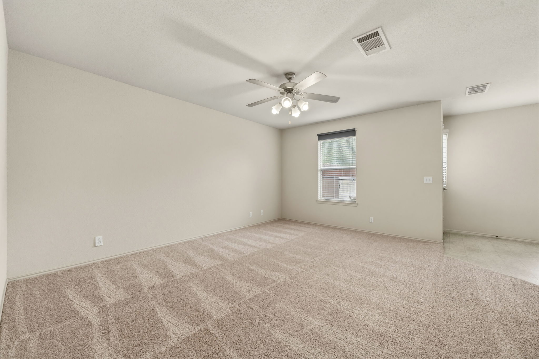 4528 Best Way Austin, TX 78725 - Photo 8 of 40 Spare room with light carpet and ceiling fan