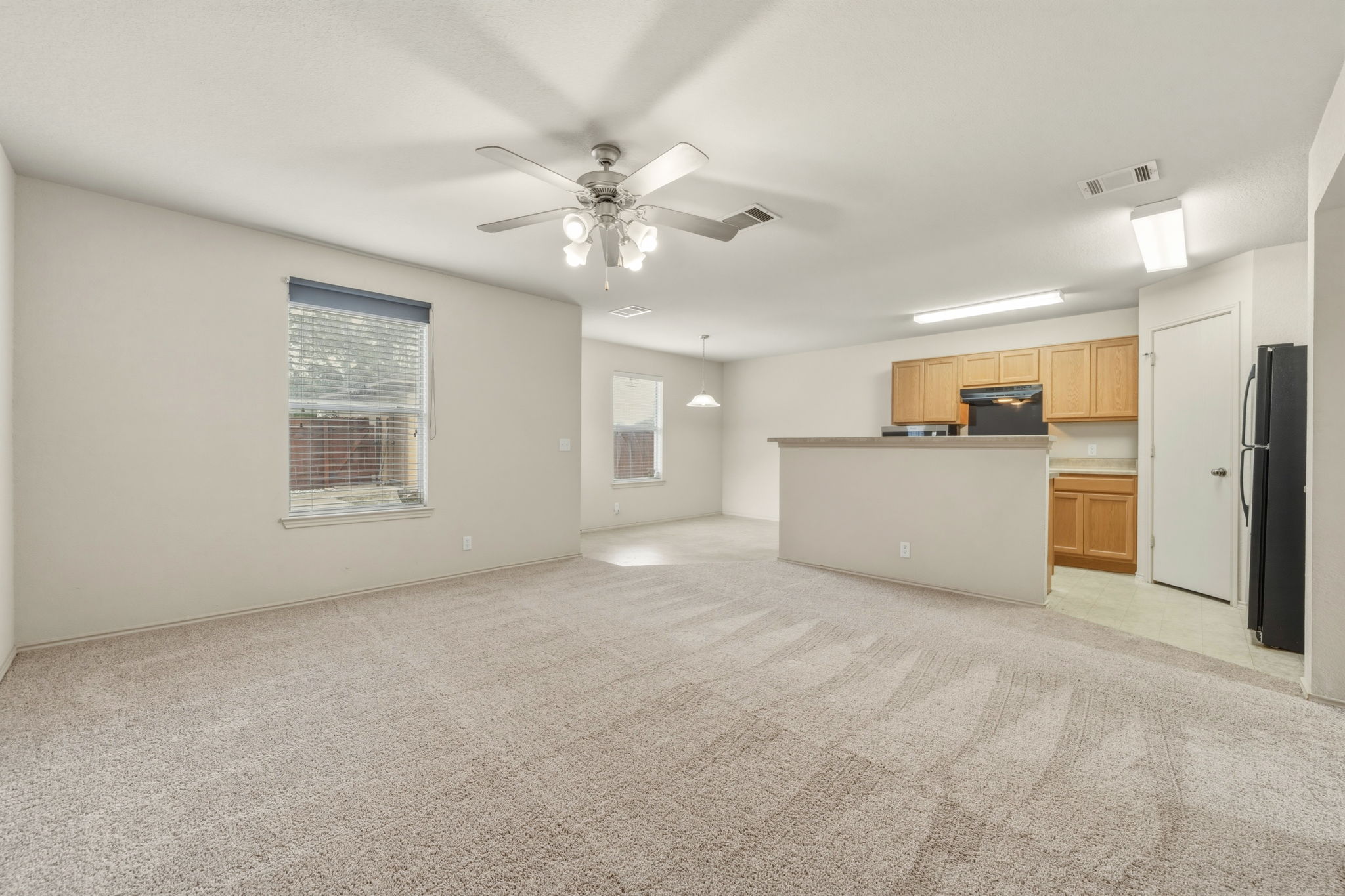 4528 Best Way Austin, TX 78725 - Photo 9 of 40 Unfurnished living room with light carpet and ceiling fan