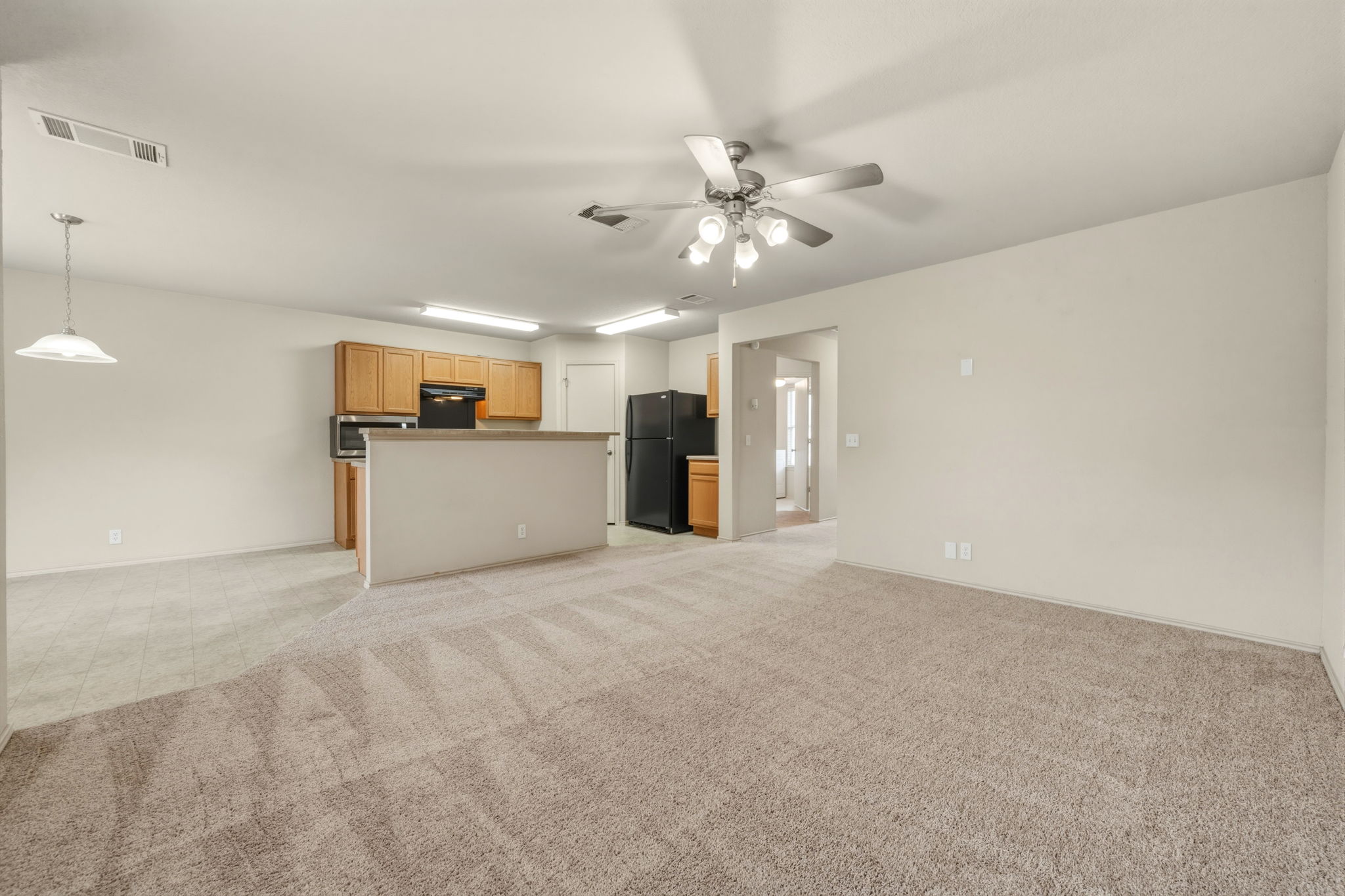 4528 Best Way Austin, TX 78725 - Photo 10 of 40 Unfurnished living room featuring light carpet and ceiling fan