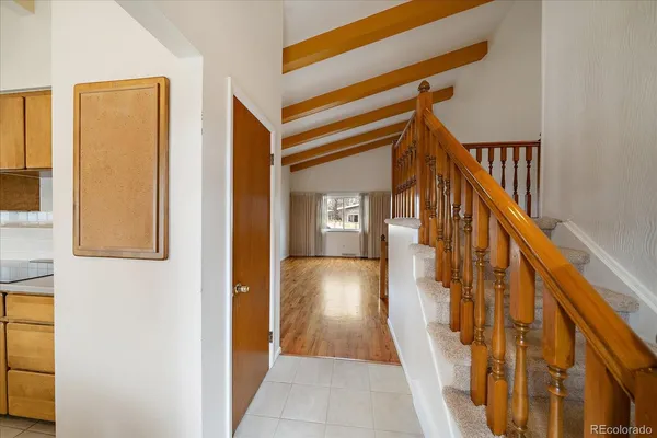 a view of a hallway with wooden floor and staircase