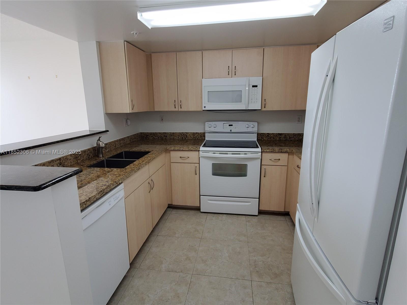 3000 Coral Way, Unit 1121 Miami, FL 33145 - Photo 5 of 12 a kitchen with a stove sink and refrigerator