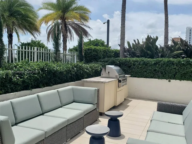 a view of a terrace with couches and a fire pit