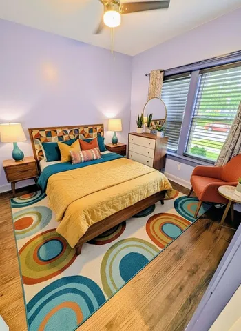 a bedroom with two beds and a dresser