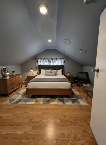 a spacious bedroom with a bed and a view of en suite bathroom