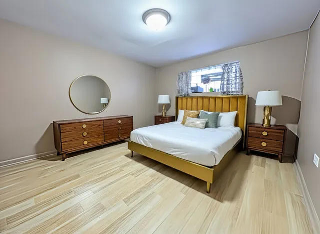 a bedroom with a bed and window