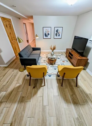 a living room with dining room and wooden floor