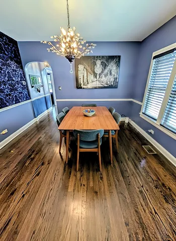 a view of a dining room with furniture and chandelier