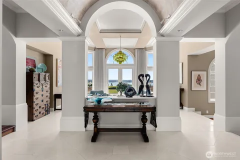 a living room with furniture and a chandelier