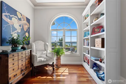 a living room with furniture a fireplace and a chandelier
