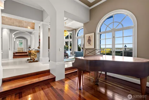 a bedroom with a large bed and a chandelier