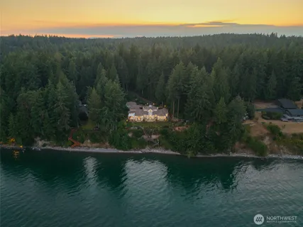 a front view of a house with swimming pool having outdoor seating