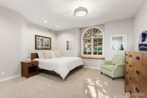 a living room with furniture a clock and a large window