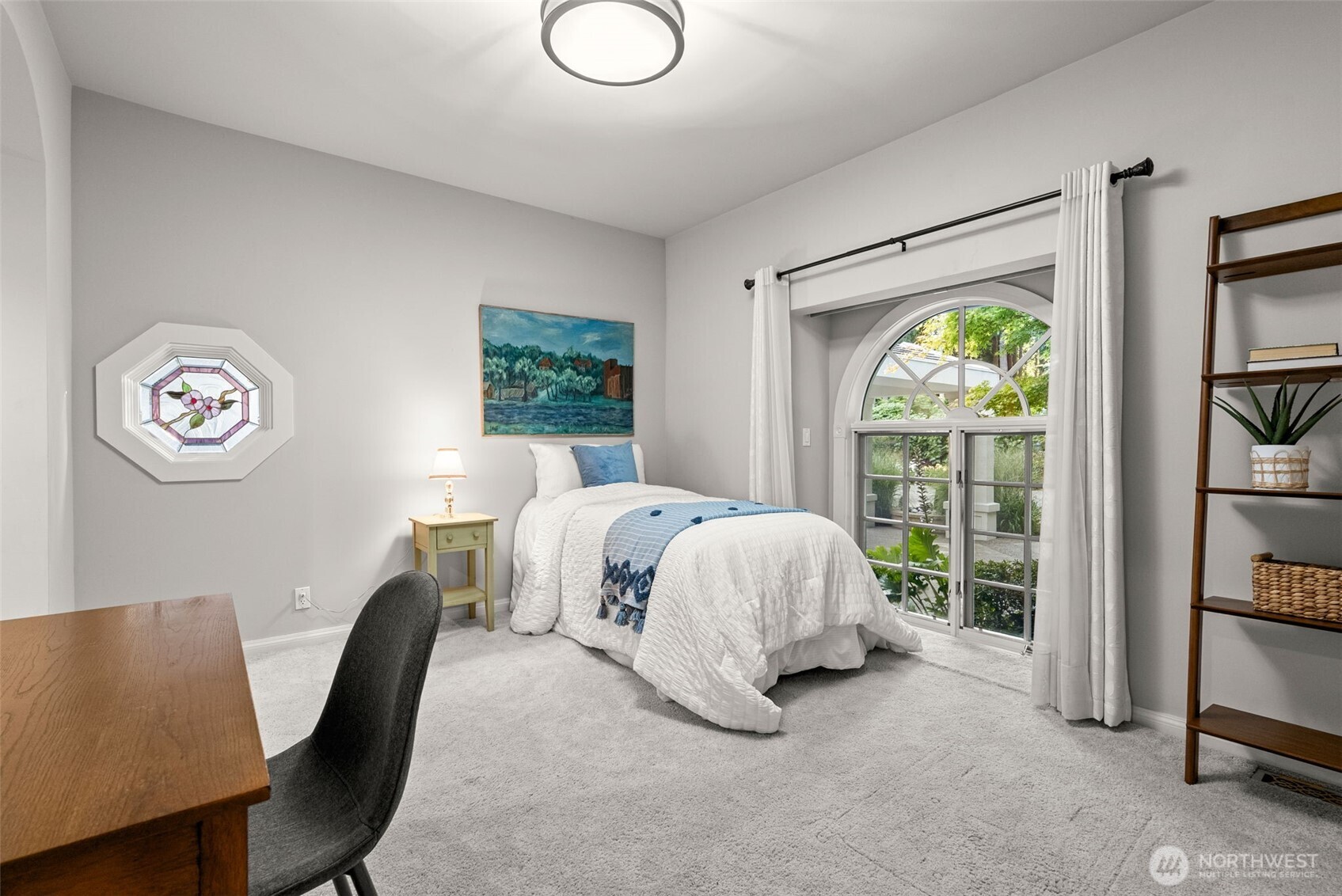 13020 Thomas Road Northwest Gig Harbor, WA 98329 - Photo 27 of 37 a bed room with a bed and a chair