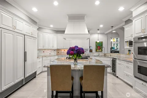 a view of a dining room with furniture a chandelier and wooden floor