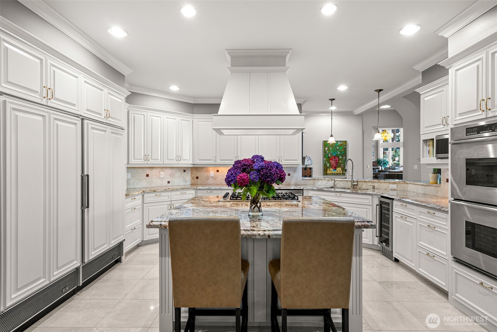13020 Thomas Road Northwest Gig Harbor, WA 98329 - Photo 30 of 37 a kitchen with stainless steel appliances kitchen island granite countertop a dining table chairs sink and cabinets
