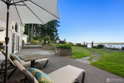 a roof deck with a couple of chairs