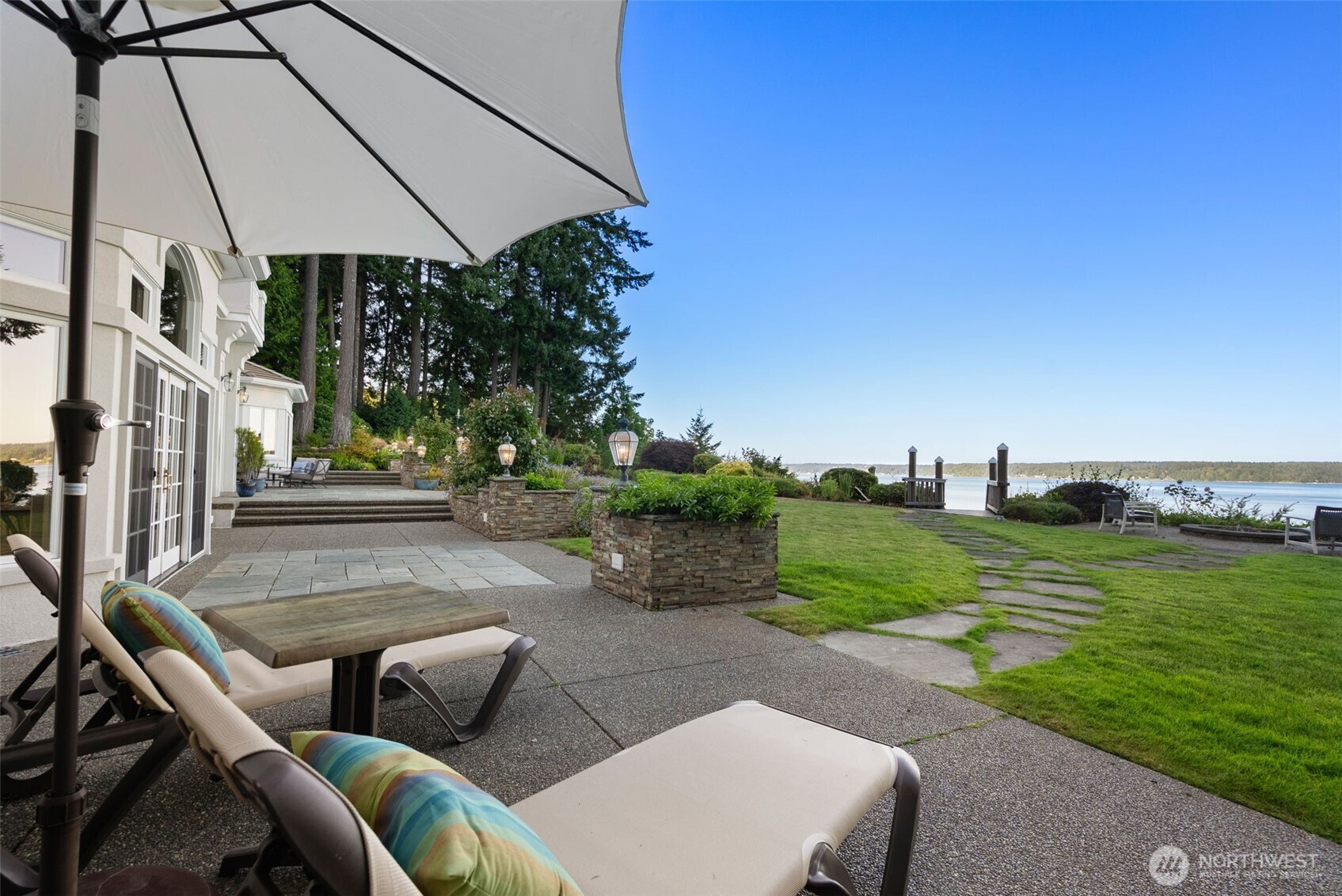 13020 Thomas Road Northwest Gig Harbor, WA 98329 - Photo 35 of 37 a view of a patio with a table and chairs under an umbrella
