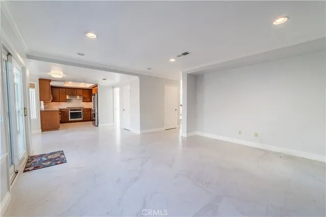 an empty room with furniture and view of bedroom