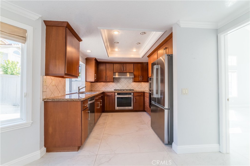23971 Frigate Drive Laguna Niguel, CA 92677 - Photo 15 of 48 a large kitchen with stainless steel appliances granite countertop a stove a sink and a refrigerator