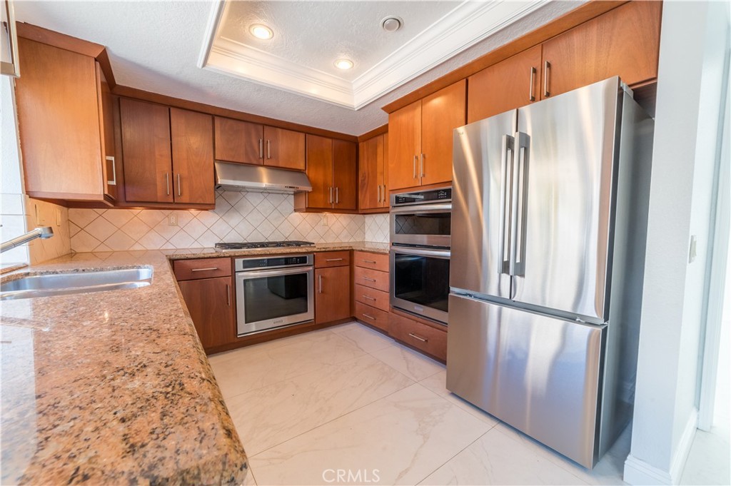 23971 Frigate Drive Laguna Niguel, CA 92677 - Photo 16 of 48 a kitchen with stainless steel appliances granite countertop a refrigerator stove and sink