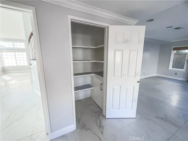 a view of a hallway with wooden floor and closet
