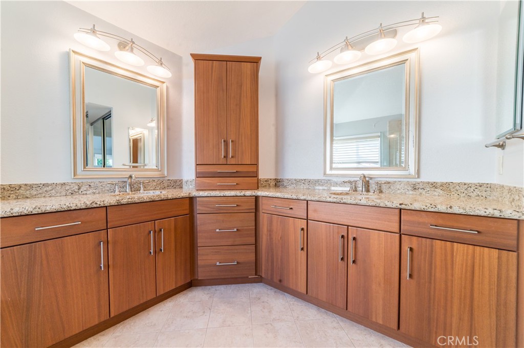 23971 Frigate Drive Laguna Niguel, CA 92677 - Photo 28 of 48 a bathroom with a granite countertop double vanity sink and a mirror