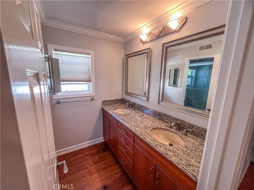 23971 Frigate Drive Laguna Niguel, CA 92677 - Photo 38 of 48 a bathroom with a granite countertop sink a mirror and shower