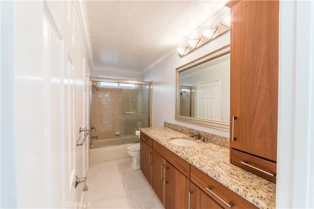 a bathroom with a granite countertop sink mirror bathtub and shower