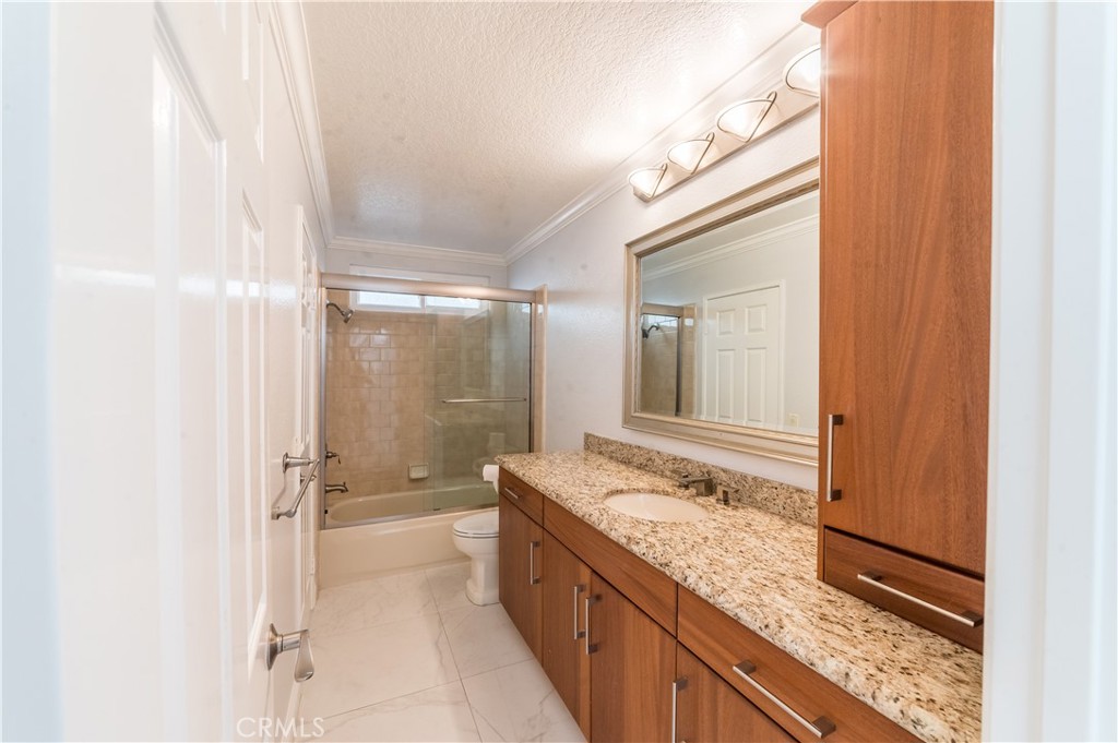 23971 Frigate Drive Laguna Niguel, CA 92677 - Photo 10 of 48 a bathroom with a granite countertop sink mirror bathtub and shower