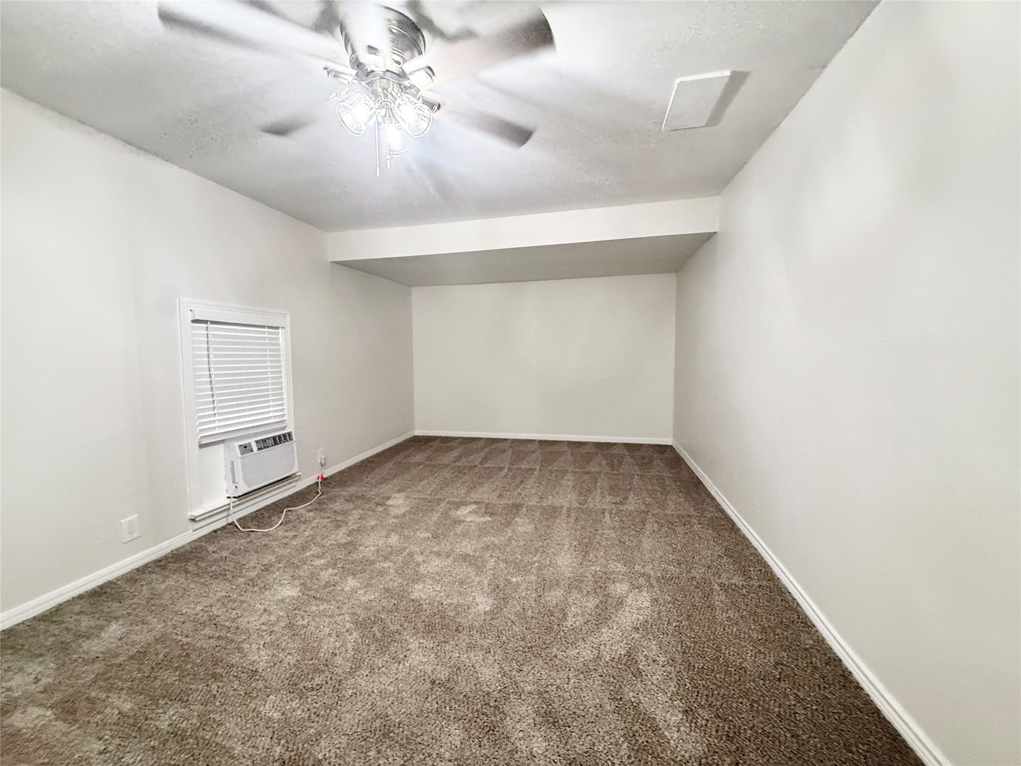 832 South Anderson Street Angleton, TX 77515 - Photo 10 of 19 an empty room with chandelier fan and windows