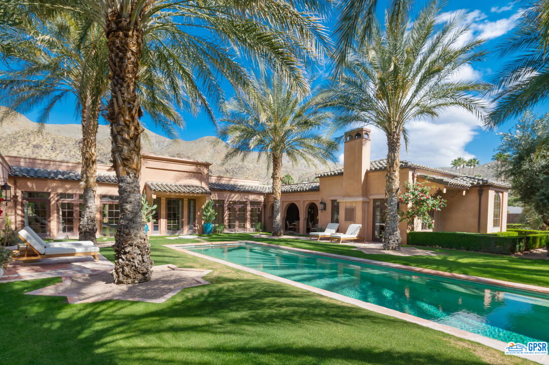 1650 Ave Sevilla Palm Springs, CA 92264 - Photo 13 of 74 a front view of a house with a yard table and chairs